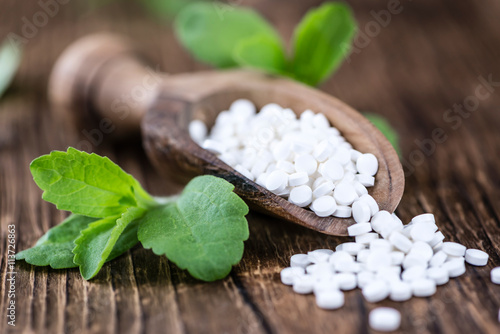 Stevia sweetener on wooden background photo