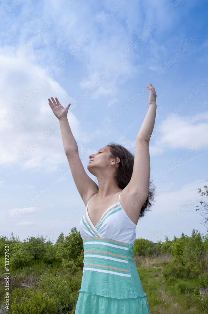 Girl in sundress raised her hands to the sky Girl in sundress raised her hands to the sky