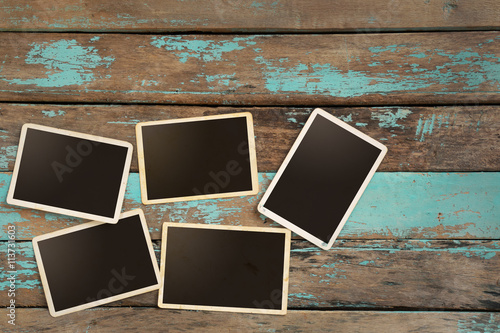 Empty old instant paper photo album on wood table - blank photo frame vintage...