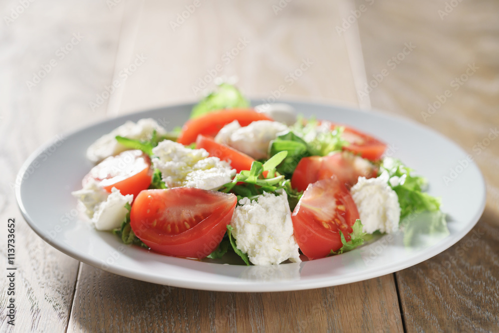 summer light salad with tomatoes, mozzarella and rocket leaves