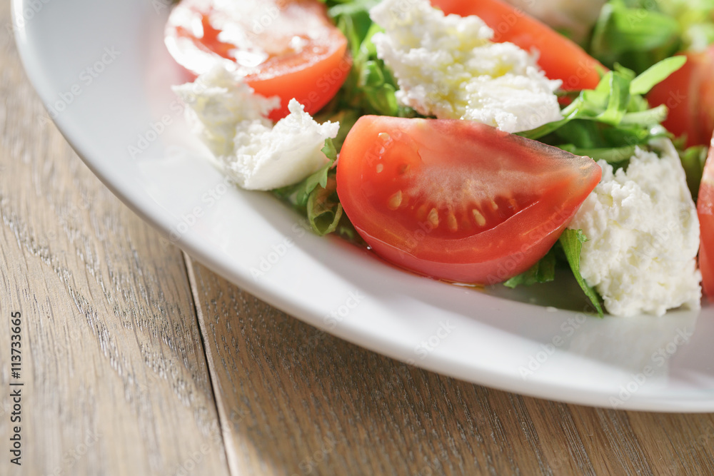 summer light salad with tomatoes, mozzarella and rocket leaves