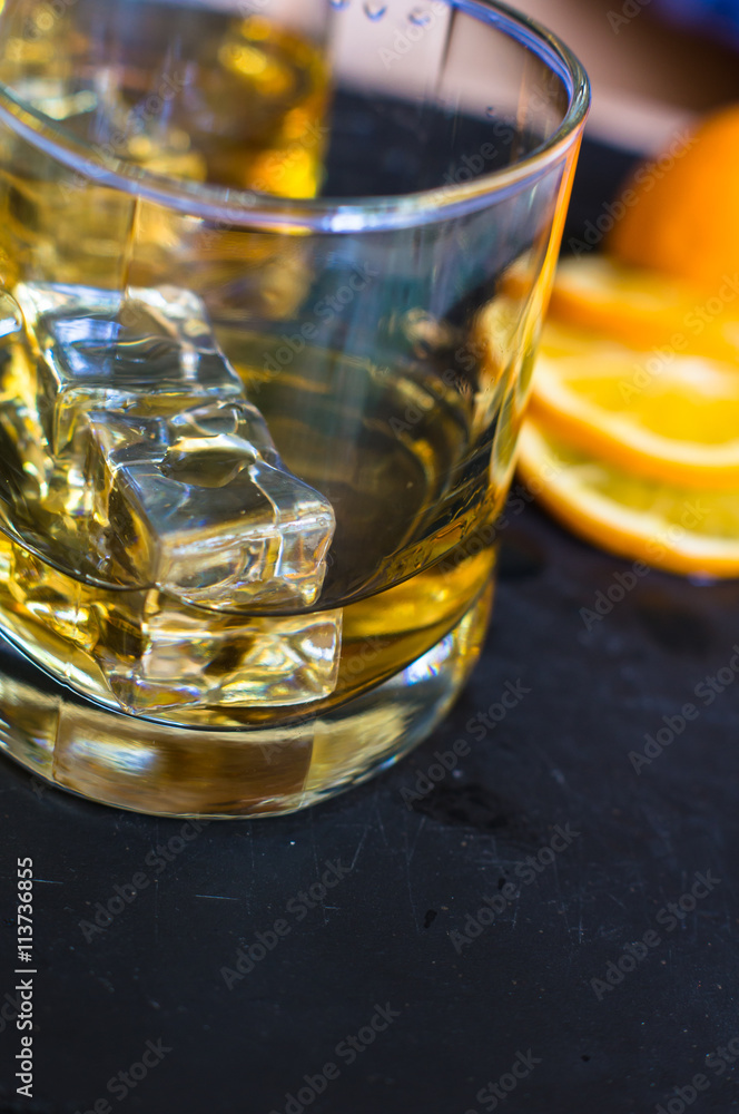 Glass of wiskey, lemon and ice