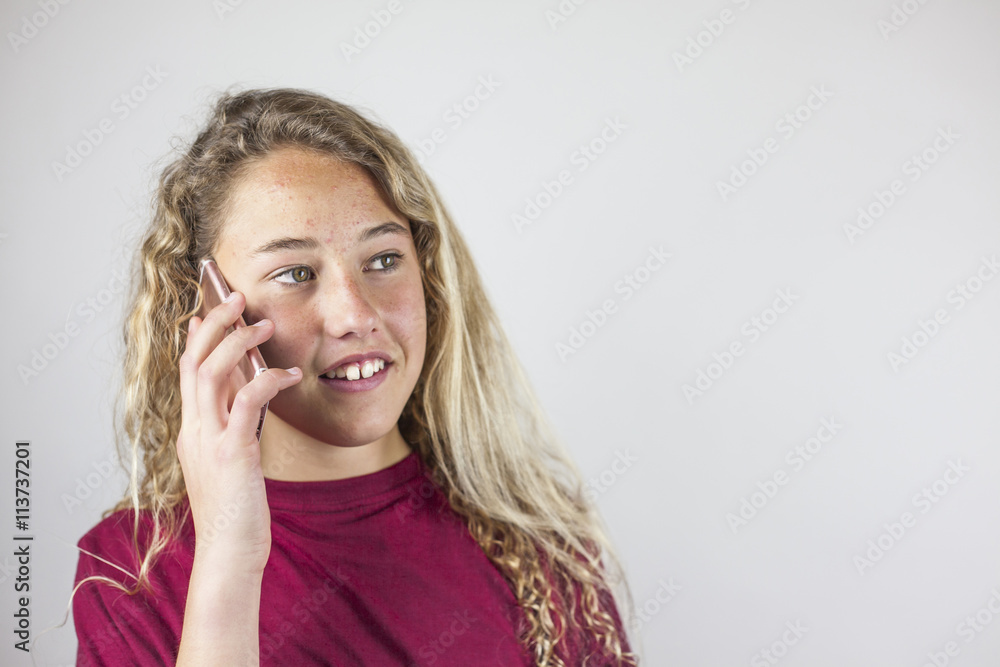 Close up portrait of blonde teenager talking in the phone Close up portrait of blonde teenager talking in the phone