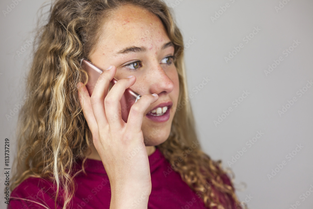 Close up portrait of blonde teenager talking in the phone Close up portrait of blonde teenager talking in the phone