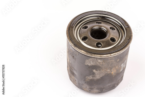Old used car oil filter isolated over white background
