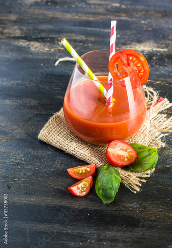 Juice of tomatoes on rustic background photo