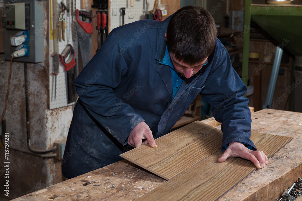 Carpenter working on a Wooden Boards in his Workshop Carpenter working on a Wooden Boards in his Workshop