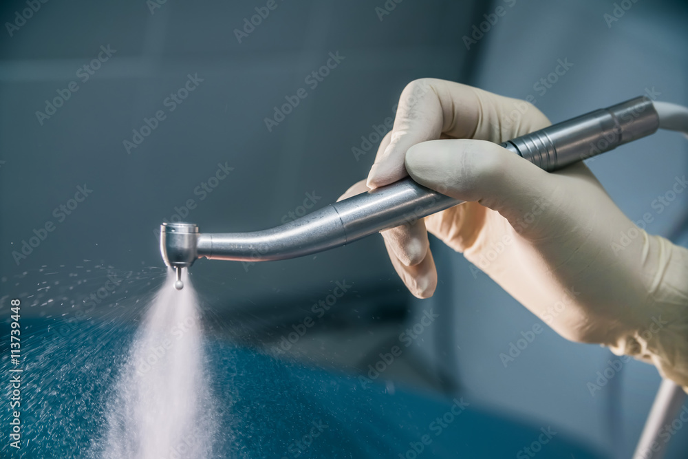 dental drill in the hand of the doctor dentist StockFoto Adobe Stock