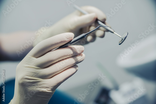 dentist holding a device for operation close up