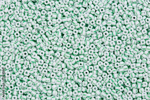 White beads with green lines.