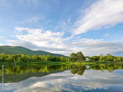 Fototapeta Naklejka Na Ścianę i Meble -  Reflection of natural tree and sky in a lake