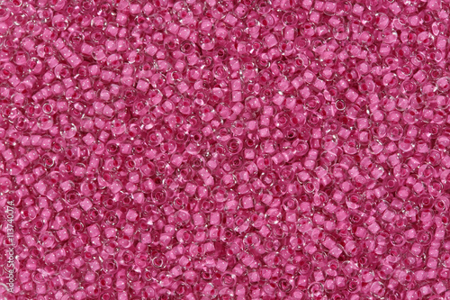 Background of glass beads in pink with highlights.