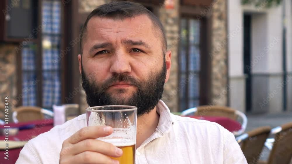 Young happy man drinking beer in cafe in the street in the city, 4K
Young happy man drinking beer in cafe in the street in the city, 4K