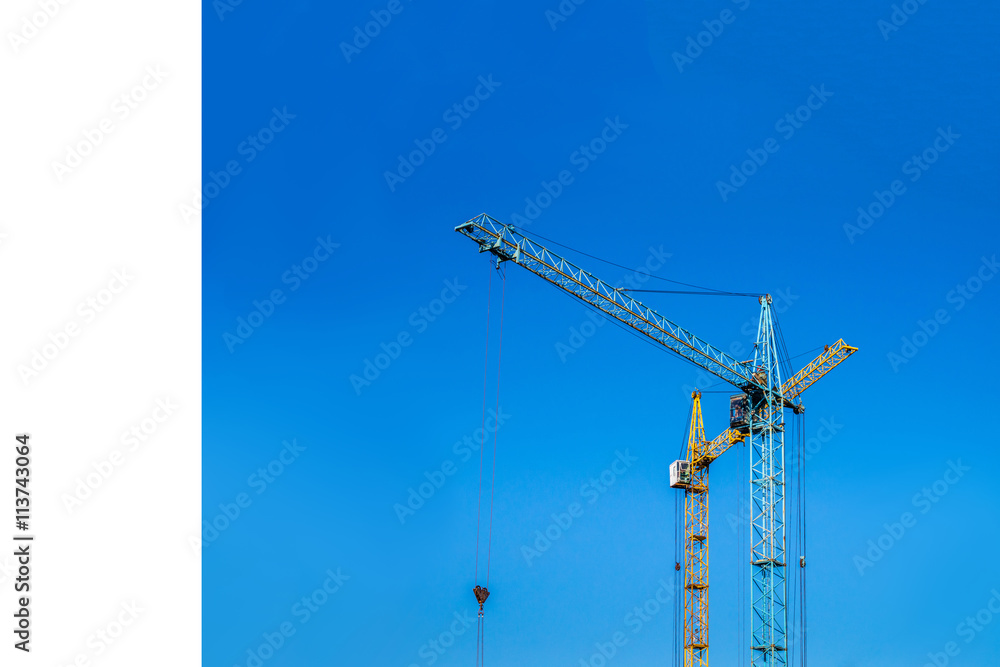 Two cranes against the blue sky. Two cranes against the blue sky.
