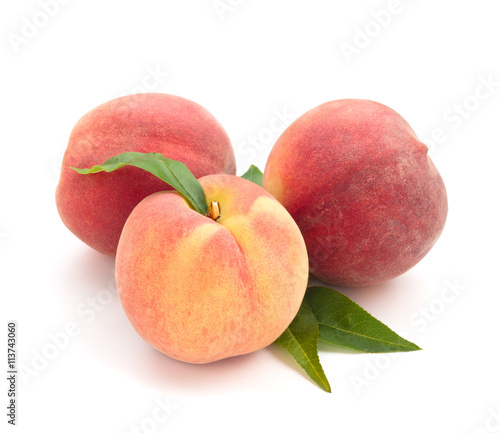 Ripe peaches with leaves.