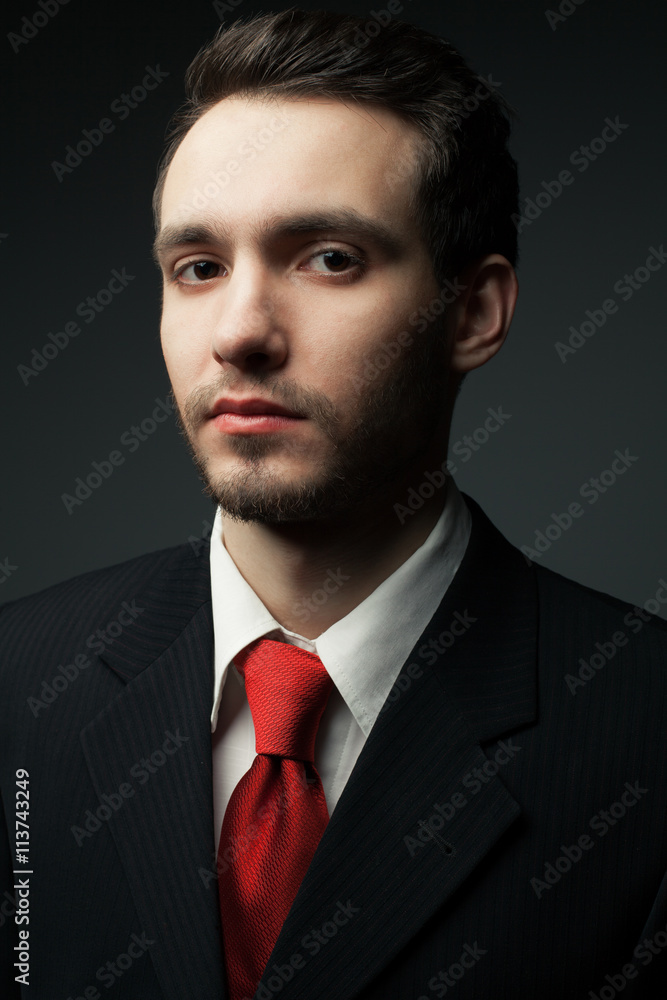 Portrait of a young handsome man (businessman) in black suit Portrait of a young handsome man (businessman) in black suit