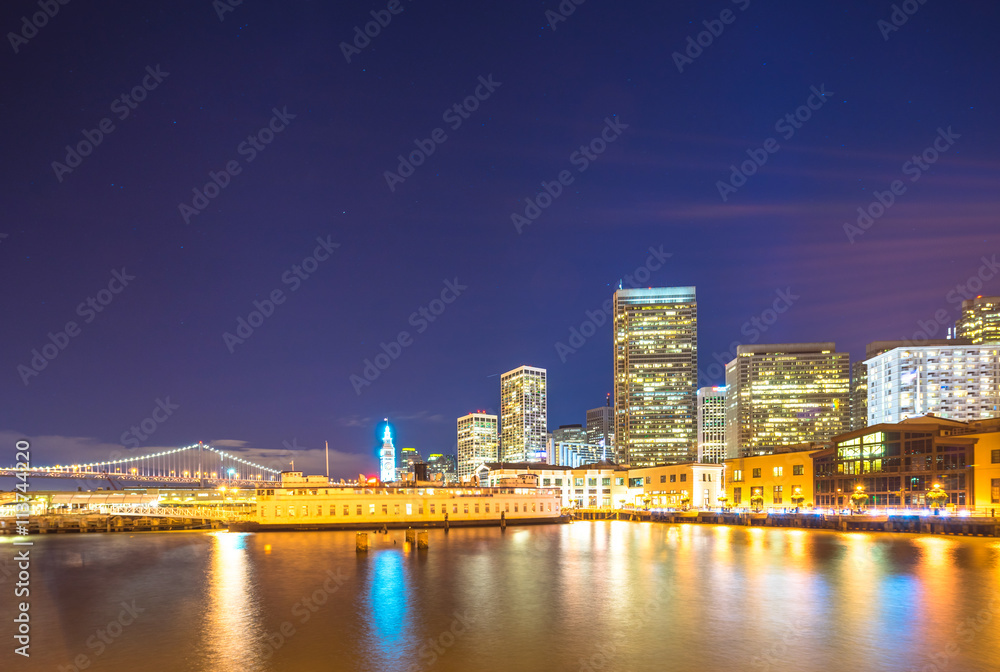 modern buildings near water in san francisco at night