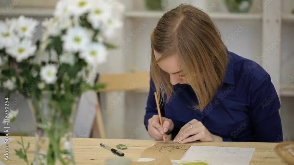 Young woman draws still life with pencil. Student learns to draft geometric shapes of object Young woman draws still life with pencil. Student learns to draft geometric shapes of object