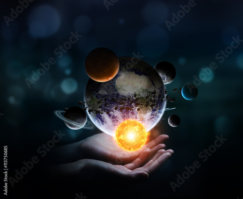 Businesswoman holding solar system in his hand