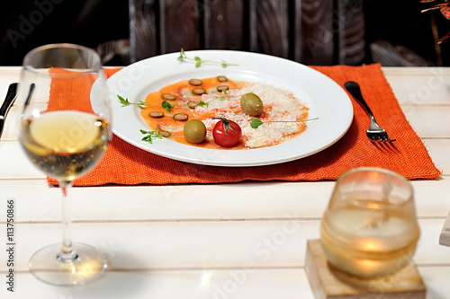 image of raw and fresh salmon sliced topped on ice in dish