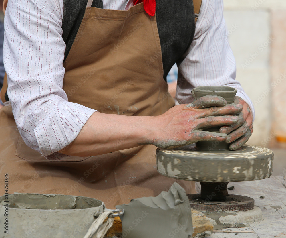 craftsman potter shaping clay to make a beautiful vase handmade