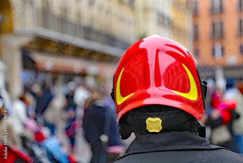 Chief of firefighters with red Hardhat checking people
