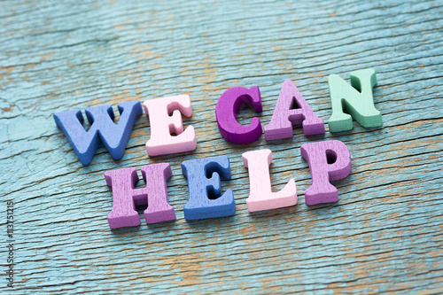 We can help phrase on vintage wooden background
