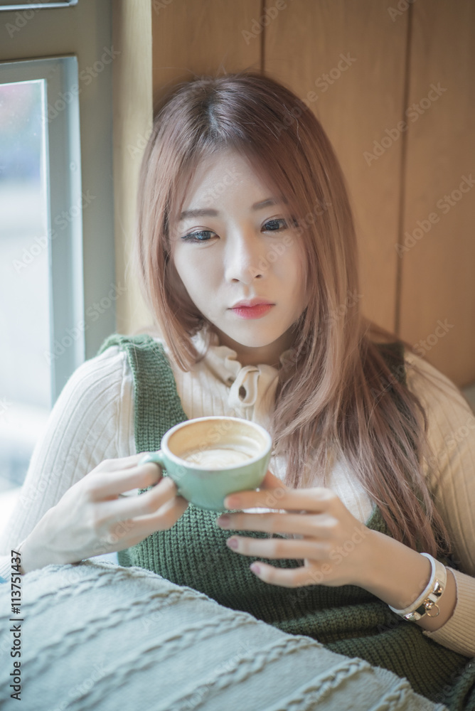 portrait of attractive asian girl in coffee shop portrait of attractive asian girl in coffee shop