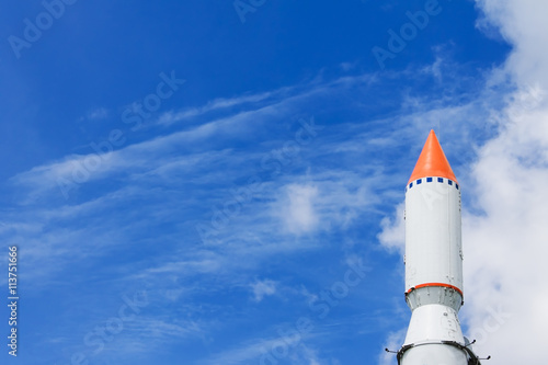 Rocket in the blue sky with clouds