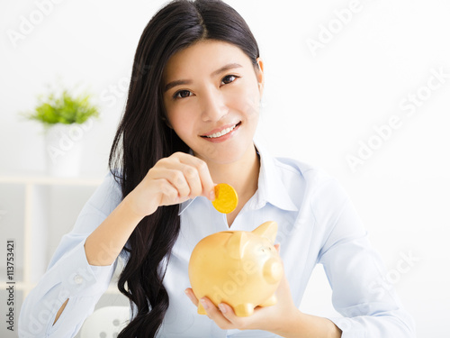 young business woman with  piggybank photo