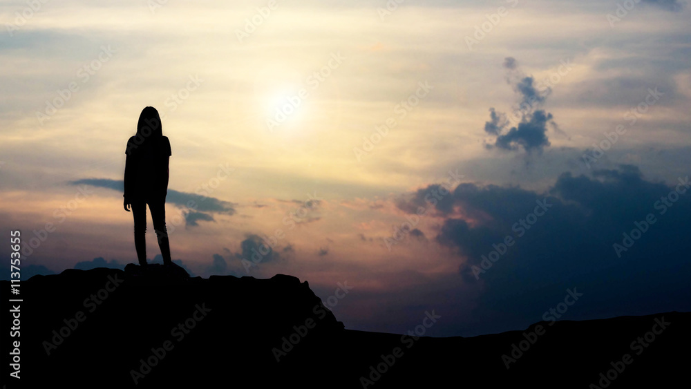 silhouette of girl looking towards the sunset