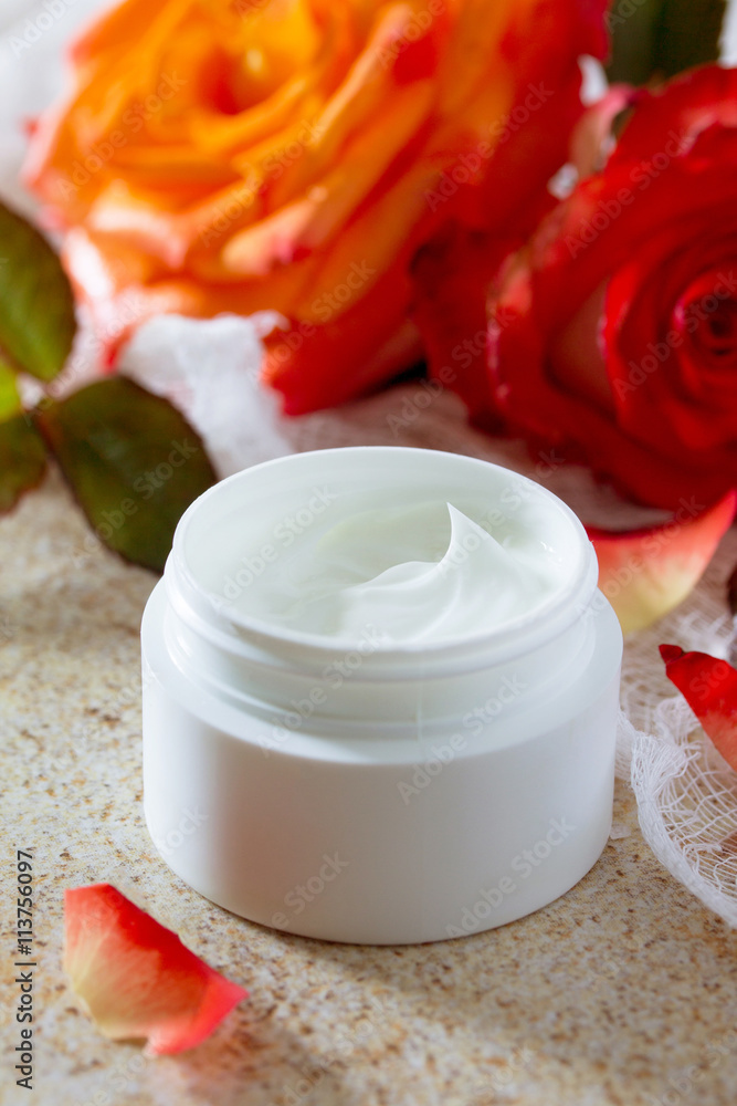 Face cream with roses on a brown stone fone- beauty salon. Face cream with roses on a brown stone fone- beauty salon.