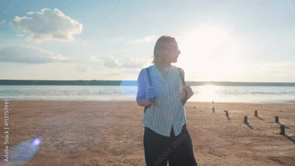 Portrait of young attractive woman on the beach during sunset or sunrise Portrait of young attractive woman on the beach during sunset or sunrise
