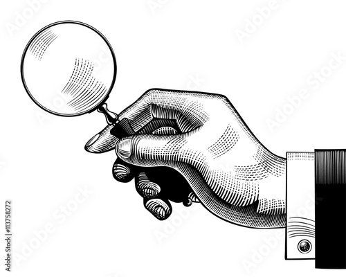 Hand with an old magnifying glass