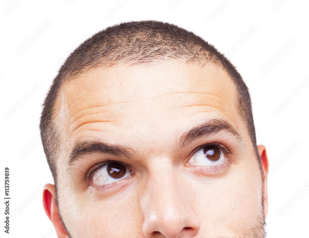 Obraz premium Half face of a young man looking up, isolated on white backgroun