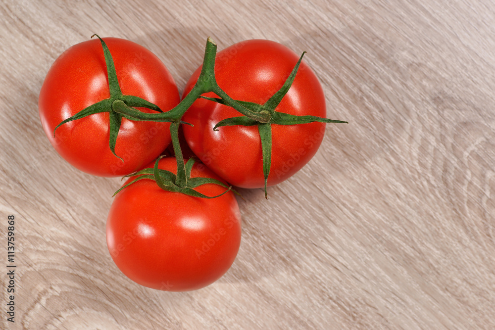Tomatoes, bunch of vegetables on a wooden table, view from above Tomatoes, bunch of vegetables on a wooden table, view from above