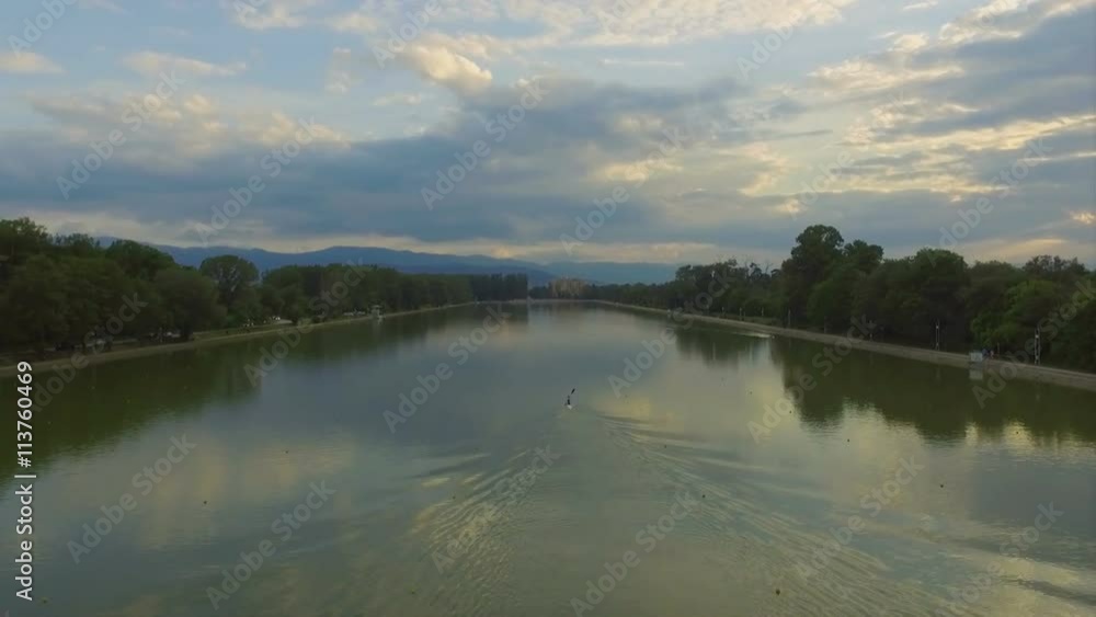 Aerial view of a person kayaking in artificial lake Aerial view of a person kayaking in artificial lake