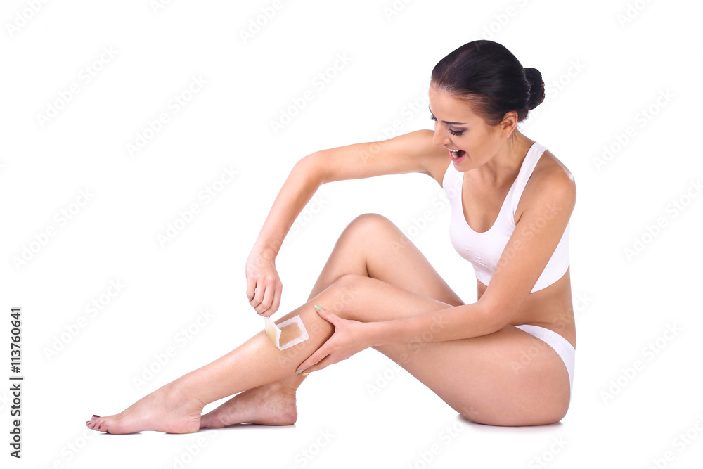 woman depilating her legs woman depilating her legs