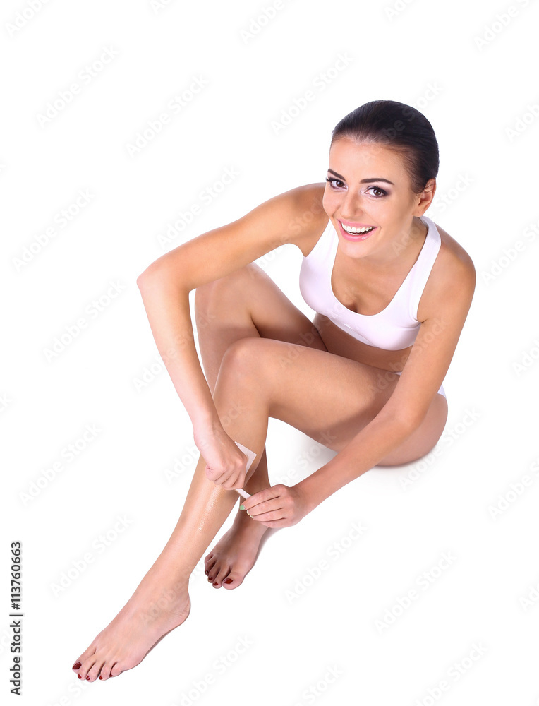 woman depilating her legs - obrazy, fototapety, plakaty 