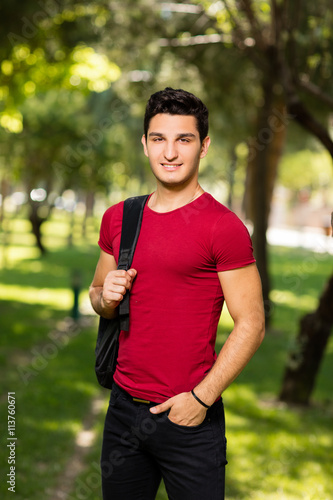 University student posing in park.