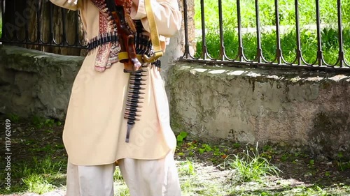 terrorist with a machine gun in a city park