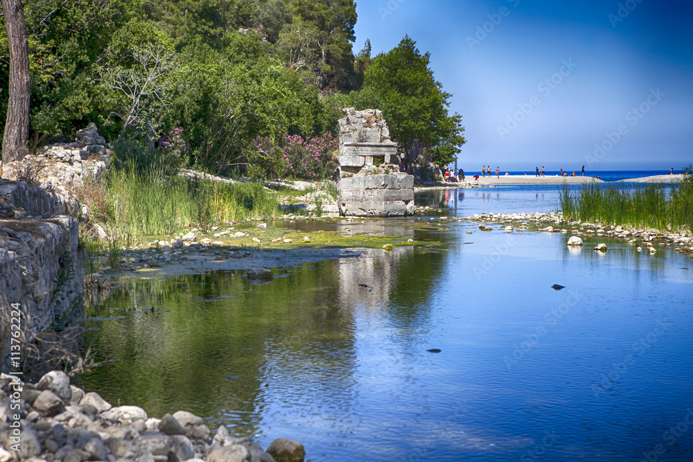 Entrance to the ruins of the ancient city of Olympus, the village of Cirali in Turkey in the valley of the Ulupinar River, at the foot of Mount Tahtali,