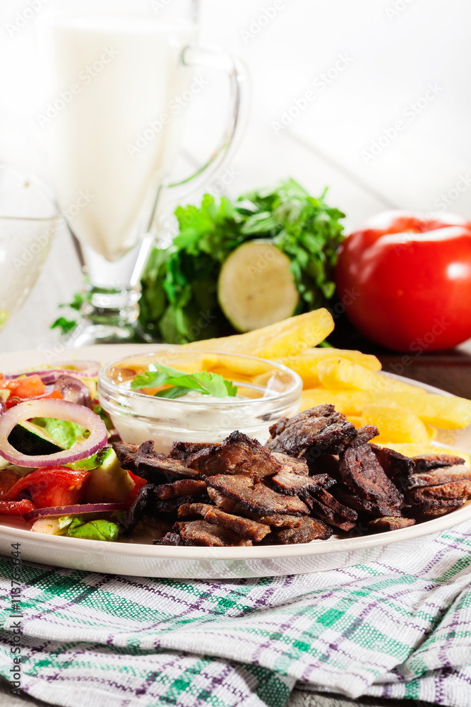 Grilled meat with French fries and fresh vegetables Grilled meat with French fries and fresh vegetables