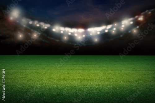 empty football field with stadium at night