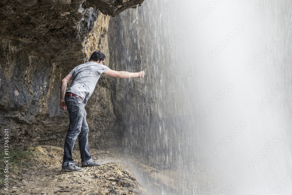 man showering in the waterfall man showering in the waterfall
