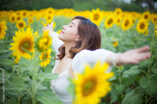 Young asian woman in sunflower field