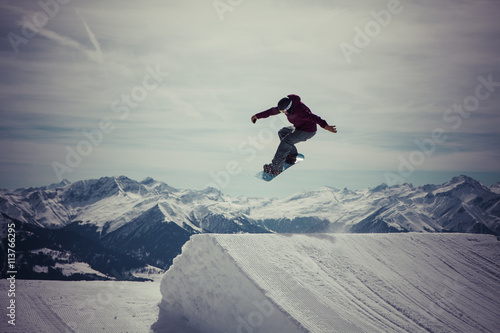 Snowboard jumps a 180