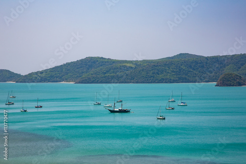 Beautiful Sea with boat and green mountain on background