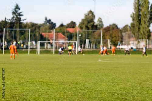 Blurred soccer players playing amateur soccer match