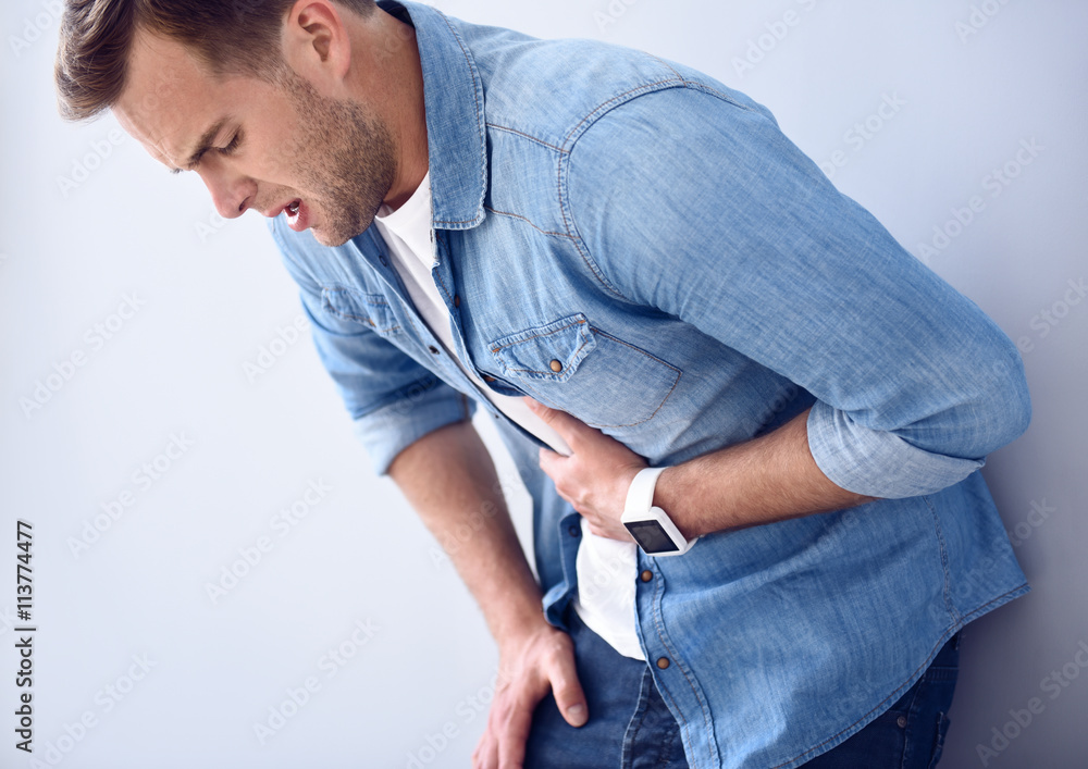 Sick moody man standing isolated on white background Sick moody man standing isolated on white background